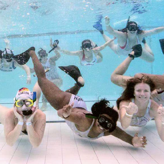 Group of swimmers underwater facing the camera